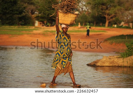 Bandiagara, Mali, Africa - August 27, 2011 Pregnant woman carrying firewood for their home