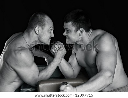 Two strong mans armwrestling in atheletic common-room