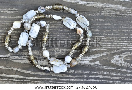 Beads from natural stones on the old wood background