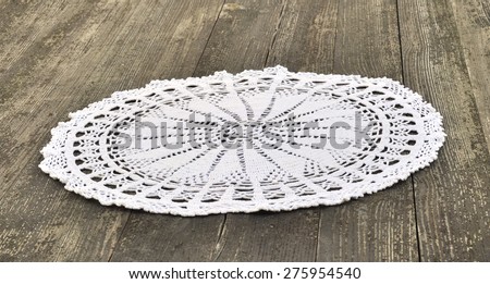 Vintage napkin, tied with white thread, on a wooden table