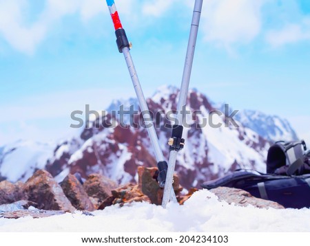 Ski mountain travel poles in the snow of mountain peak
