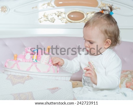 Small caucasian child on happy birthday with cake at home