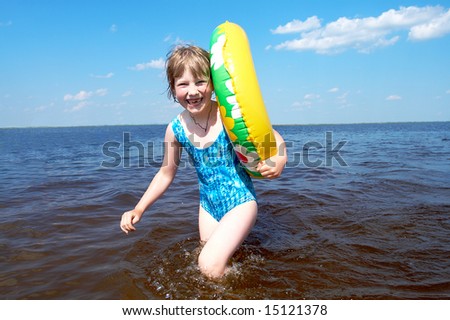 Happy girl with life buoy at sea
