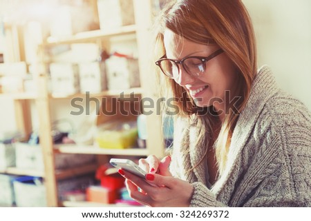 pretty woman with smartphone touching screen and using app