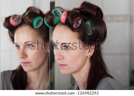 young woman with hair rollers