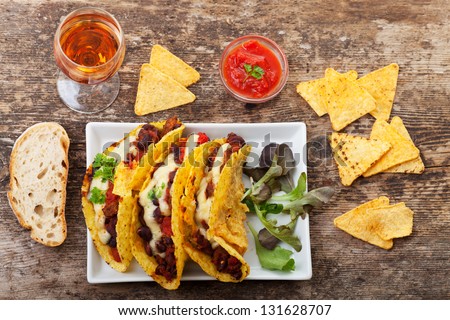 taco with chili con carne in a bowl