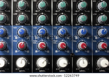 a lot of knobs on an audio engineers mixer
