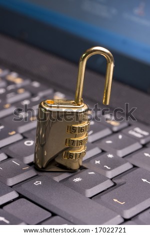 a golden padlock on a black notebook keyboard