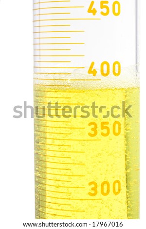 yellow fluid in a large testtube on white background