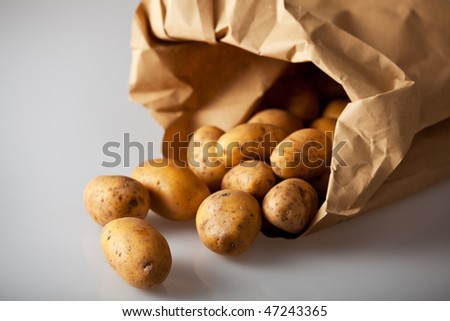 fresh potatoes in a brown paper bag