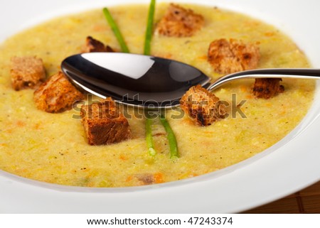 potato soup with croutons and chive strands