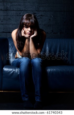 woman on a leather couch in despair