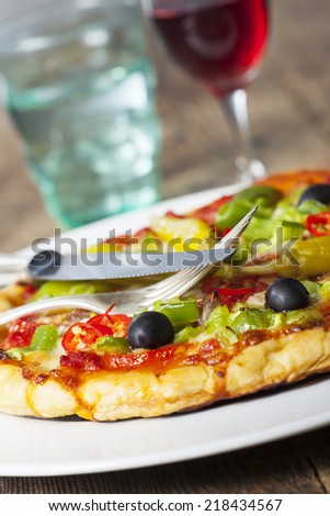 closeup of a pizza with wine