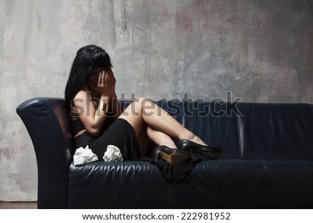 crying woman on a couch