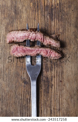 slices of a steak on a meat fork
