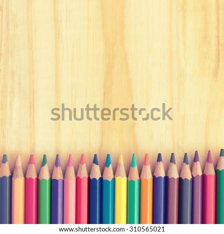 Colored pencils on a wooden board