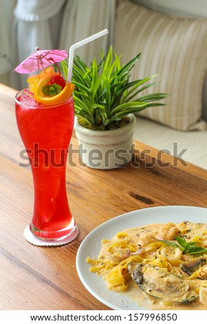 Fresh pasta with king prawns, mussels and a chilli and herb sauce. and Fruity cocktail with lemon lime and  with orange,cherries