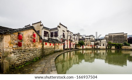Raining days in Hongcun. It\'s an ancient village near Huangshan, World Heritage Site by UNESCO, has many wonderful traditional Chinese architectures and carvings, red lanterns along the central lake.