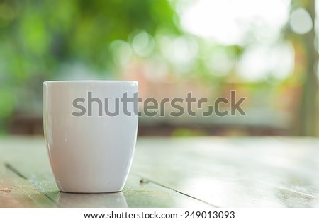white coffee mug on blur garden background