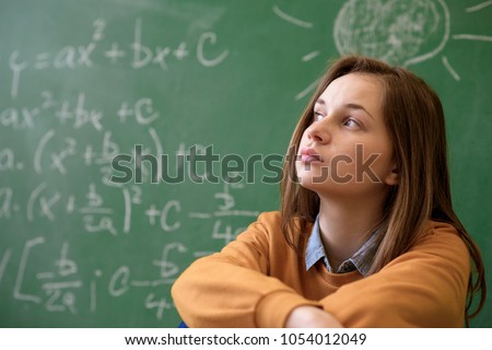 Teenager girl in math class overwhelmed by the math formula. Pressure, Education, Success concept.