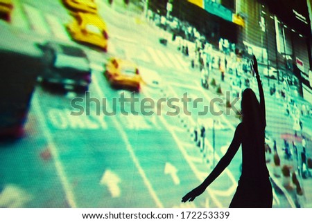 Horizontal colour image of girl dancing in front of video projection
