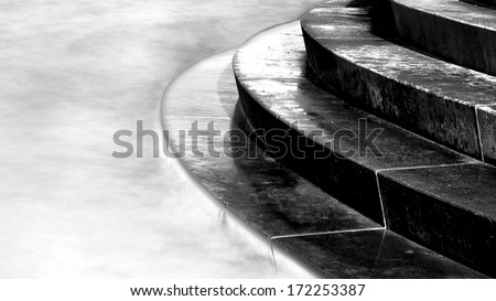 Horizontal black & white image of steps leading into sea, Portobello, Edinburgh, Scotland