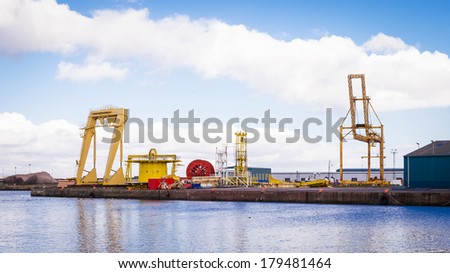 Horizontal color image of heavy machinery in docks