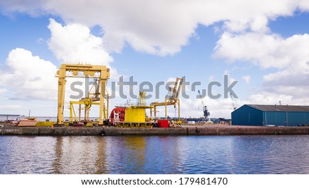 Horizontal color image of heavy machinery in docks