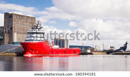 Horizontal color image of cargo ship in Edinburgh docks.