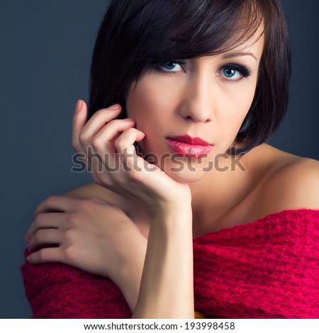 Square colour image. beautiful young woman with healthy face and clean skin isolated on dark background