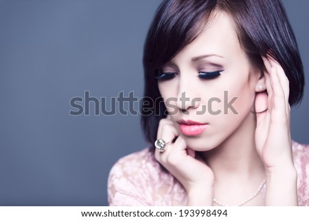 Horizontal colour image. beautiful young woman with healthy face and clean skin isolated on grey background