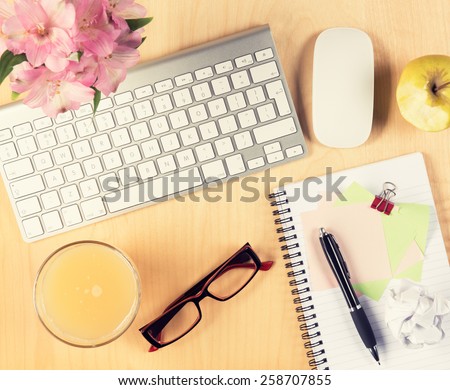 Office table with notepad, computer, reading glasses and healthy breakfast. View from above with copy space