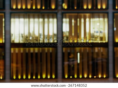 Artistic style - Defocused, blurred urban background, reflection in office windows at night