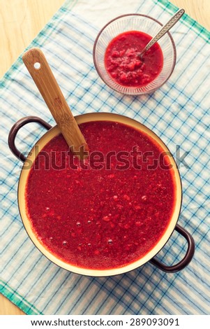 Homemade strawberry jam (marmalade) cooking. Large pot with hot jam