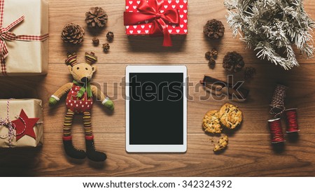 Desk view from above with digital tablet and presents, online shopping retro xmas concept with copy space
