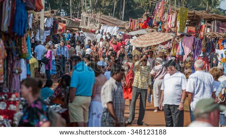 Goa, India - Circa January 2008 - Tourists and local traders at the famous weekly flea market in Anjuna, Goa