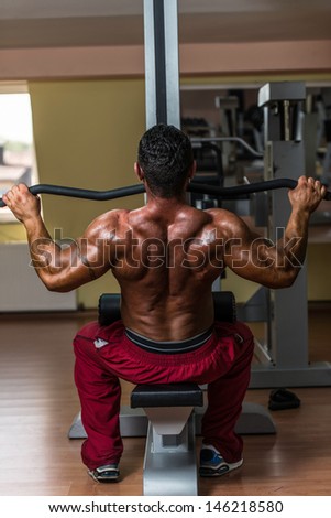 shirtless bodybuilder doing heavy weight exercise for back