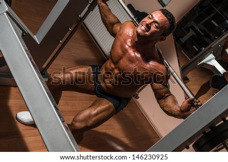 body builder doing squat with barbell