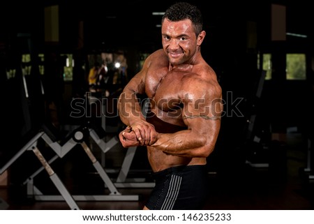 muscular body builder showing his side chest