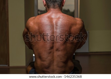 bodybuilder flexing his back