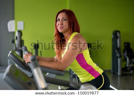 Beautiful woman exercising on an exercise bike