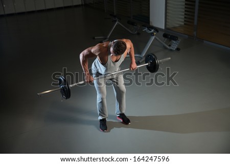 Heavy Weights. Man Doing Heavy Weight Exercise For Back