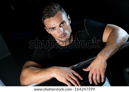 Sporty Man Resting In A Gym. Young Muscular Caucasian Man Resting At The Gym