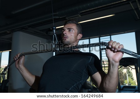 Bodybuilder Doing Heavy Weight Exercise For Back. Lat Pull down Heavy Weight Exercise For Back