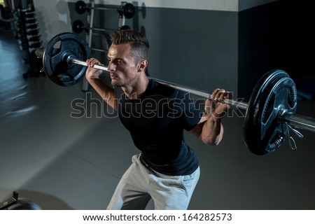 Barbell Squat. Young Athlete Doing Barbell Squats
