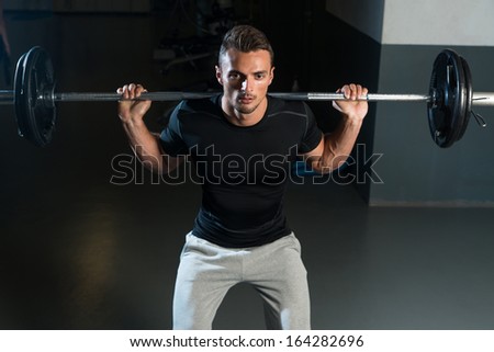 Barbell Squat. Young Athlete Doing Barbell Squats