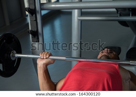 Bodybuilder Training. Young Men In Gym Exercising On The Bench Press