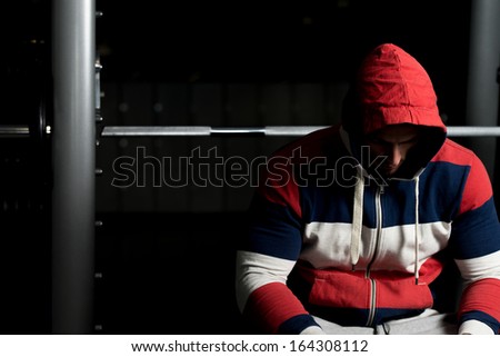 Sporty Man Resting In A Gym. Portrait Of A Young Muscular Sporty Fit Caucasian Man Resting At The Bench