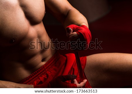 Boxer Getting Ready - Muscled Boxer Wearing Red Strap On Wrist