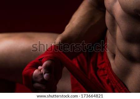 Kick Boxer Putting Straps On His Hands